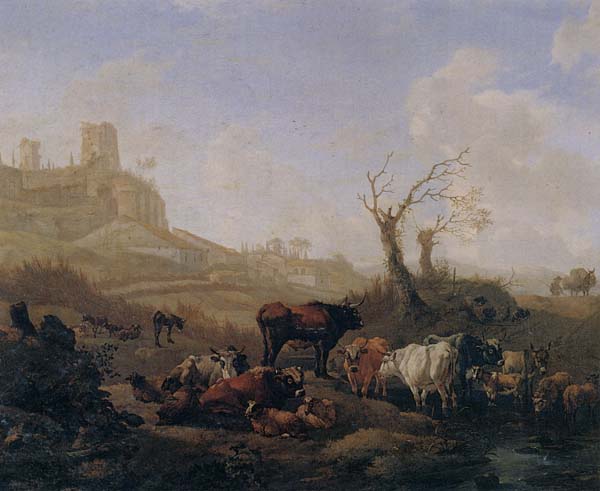 Cattle and sheep by a stream in a pasture,a town beyond